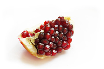 a piece of pomegranate on white background