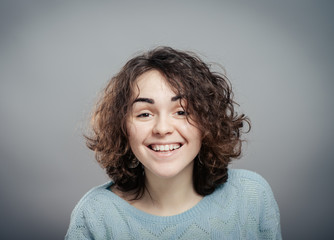 friendly smiling young woman portrait studio shot