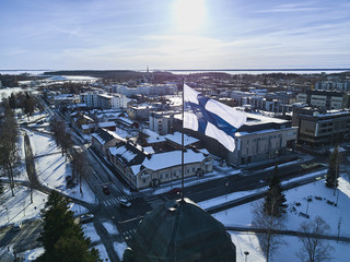 Fototapeta premium Aerial view of Finnish flag on the tower of Town Hall in Joensuu