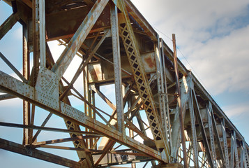 A closeup of the underside of a railroad train trestle.