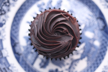 Chocolate cupcake on a plate on wooden table 