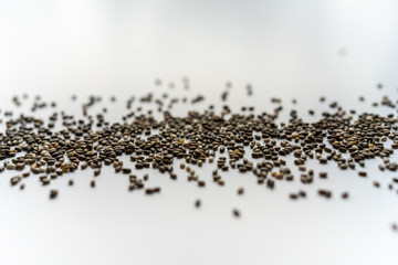 top view of line of chia seeds on a white background