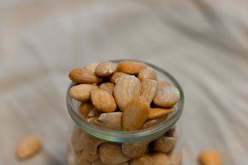 Bowl of  toasted almonds on a gray background