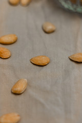 Bowl of  toasted almonds on a gray background