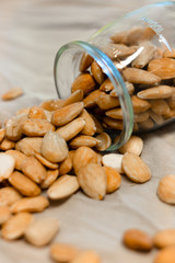 Bowl of  toasted almonds on a gray background