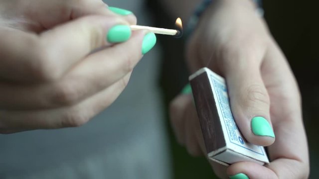The girls hand hold matches and light them.