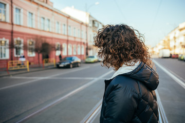 Side view unrecognizable young woman with curly hair