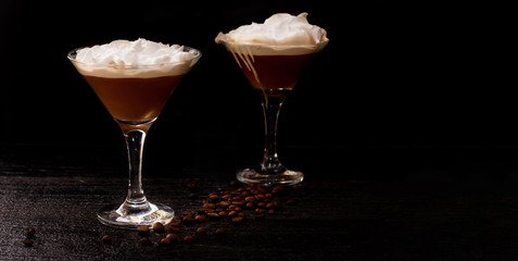 Martini glass and Baileys on a black background. horizontal banner for designers