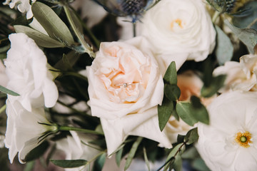 Wedding bridal bouquet of white flowers and greenery with silk ribbon