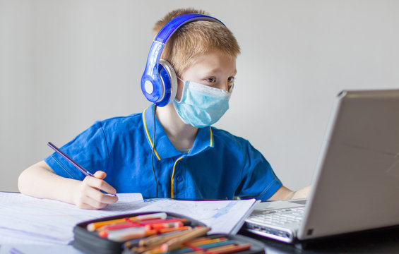 Young bopy studying homework math during her online lesson at home, social distance during quarantine, self-isolation, online education concept, home schooler