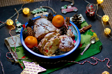 Christmas cupcake shtolen and tangerines on the background of Christmas decor