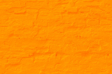 Saffron plastered brick wall texture.