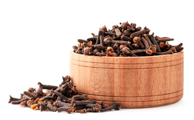 Clove spice in a plate close-up on a white. Isolated