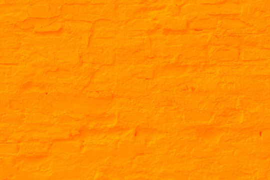 Saffron plastered brick wall texture.