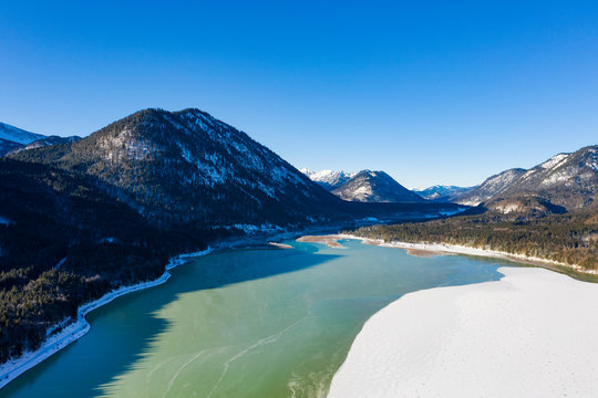 Germany, Bavaria, Lenggries, Drone view of inflow of Sylvenstein Dam in winter