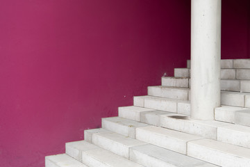 white staircase with a purple wall in the city