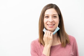 Fototapeta premium Relieved woman taking surgical mask off