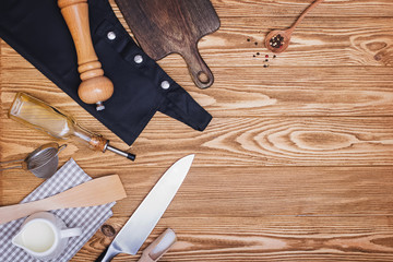Kitchen utensils and accessories on wooden table with copy space.