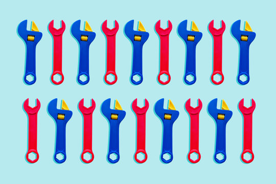 Illustration of two rows of red and blue toy wrenches