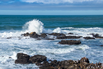 A crowning wave above the rocks