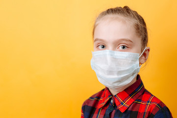 Portrait of a Teenage Girl In a Medical mask on a Yellow Background