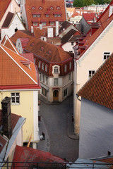 View from the height of the picturesque street of old Tallinn. The main historical attraction in Estonia. The summer season.