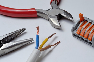 wire cutters, terminal block, wire. on a light background.Close-up.