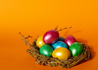 Colorful easter eggs on orange background. Happy Easter composition. Copy space.