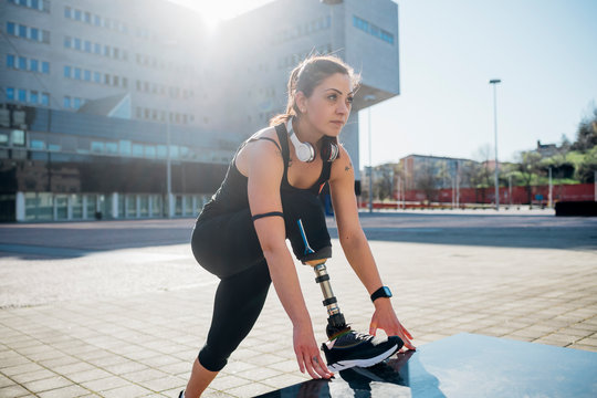 Portrait of sporty young woman with leg prosthesis in the city