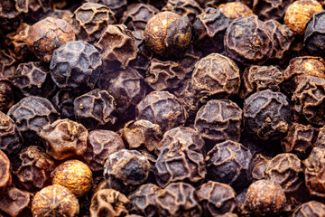 Background macrophoto of black peppercorns