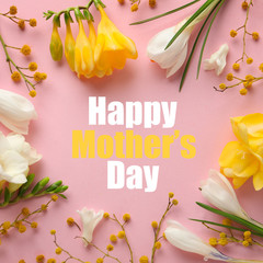 Frame made with beautiful spring flowers and phrase HAPPY MOTHER'S DAY on light pink background,...