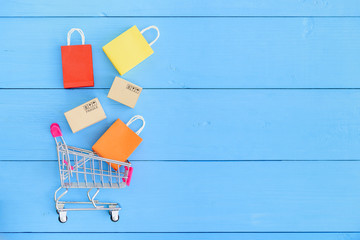 Online shopping / e-commerce and customer experience concept : Shopping cart with boxes, colored...