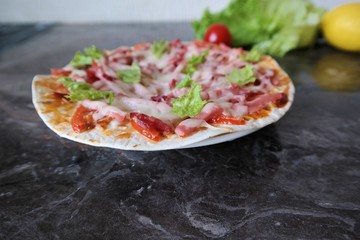 cooking delicious pizza cheese lettuce and tomatoes at home close up