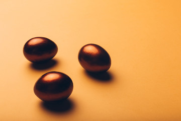 Color easter eggs on a yellow textured background.