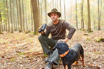Forester or hunter with a hound as a hunting dog