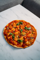 Delicious Pizza Margherita on white stone background. Homemade Pizza Margarita with Tomatoes, Basil and Mozzarella Cheese.Copy space, top view.