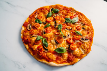 Delicious Pizza Margherita on white stone background. Homemade Pizza Margarita with Tomatoes, Basil and Mozzarella Cheese.Copy space, top view.