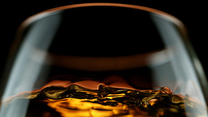 Detail of cognac in glass - obrazy, fototapety, plakaty