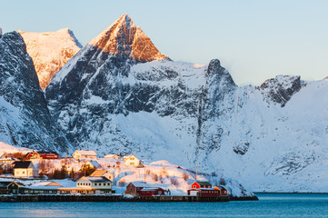Buildings in front of snow covered mountains, Norway,