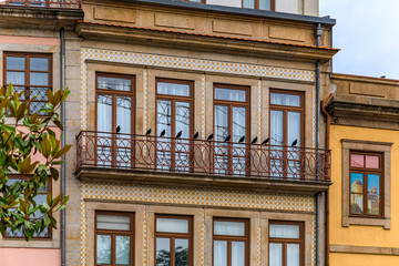 Fototapeta premium Facades of traditional houses decorated with ornate Portuguese azulejo tiles in Porto, Portugal