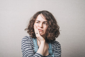 Woman toothache. Gray background