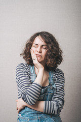 Woman toothache. Gray background