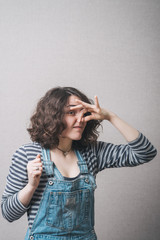 The woman closed her nose from the stench, bad smell. Gray background