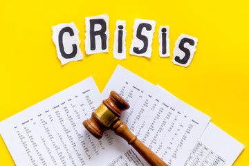 Financial crisis concept with gavel - debt, bankruptcy - on yellow background top view