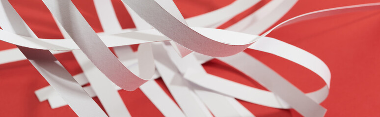 close up view of white paper stripes on red background, panoramic shot