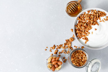 Granola and greek yogurt breakfast with honey and nuts