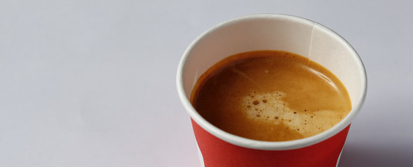 Take-out coffee in opened thermo cup against white.