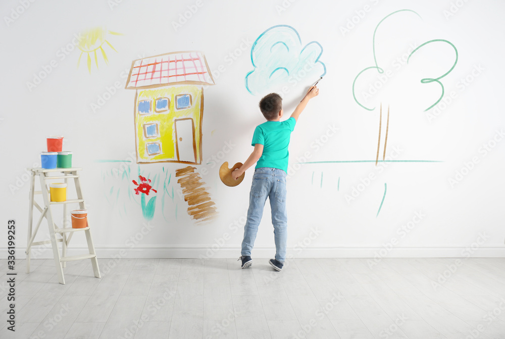 Sticker little child drawing cloud on white wall indoors