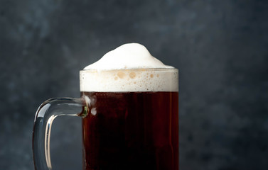 glass of beer on stone background with copy space for your text