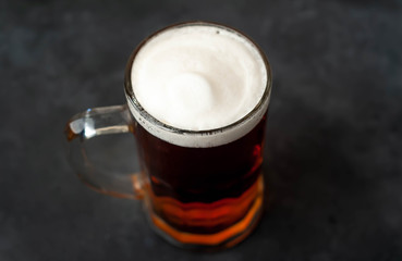 glass of beer on stone background with copy space for your text